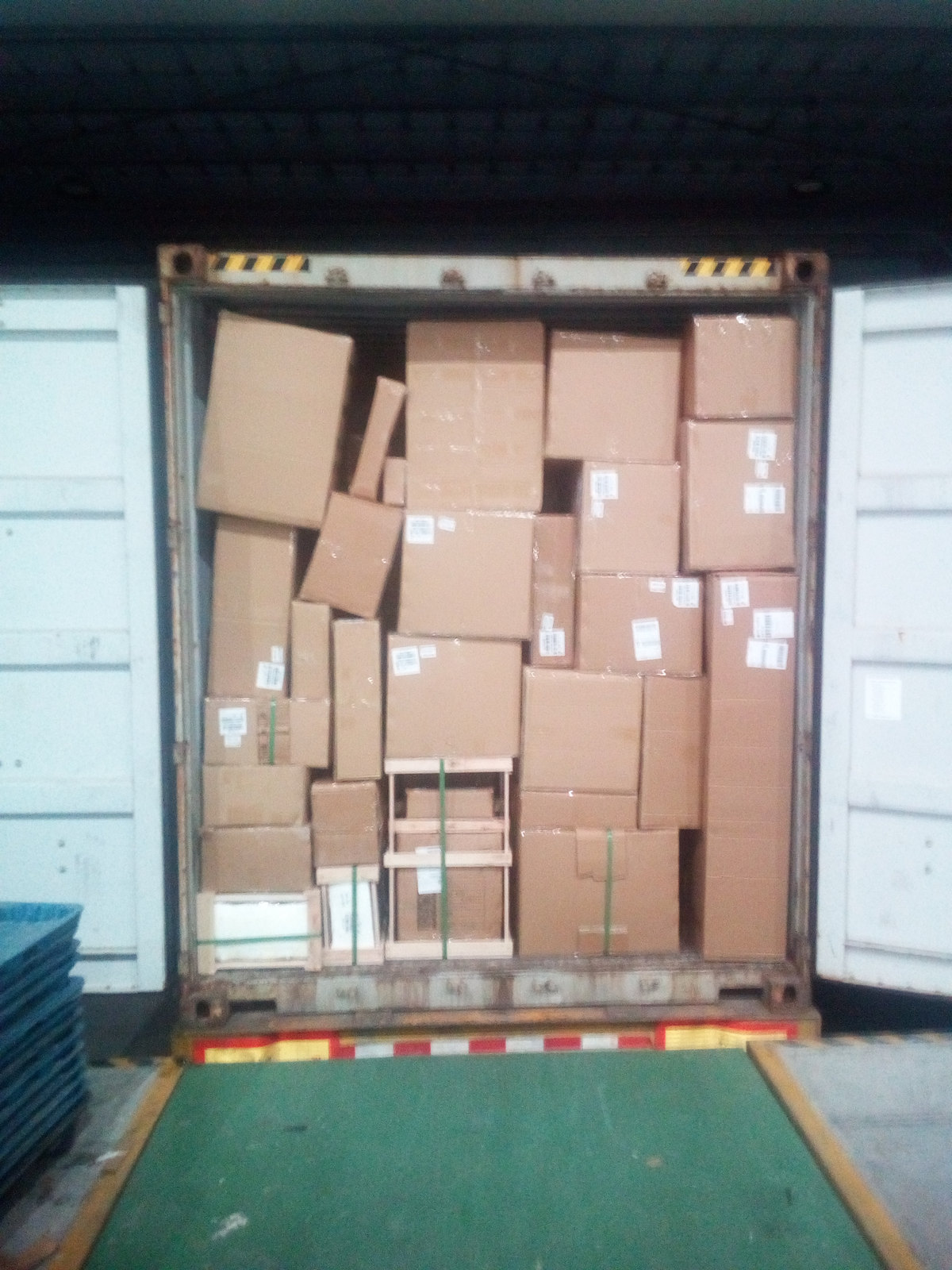 Loaded container interior with cartons stacked to the top of the door opening